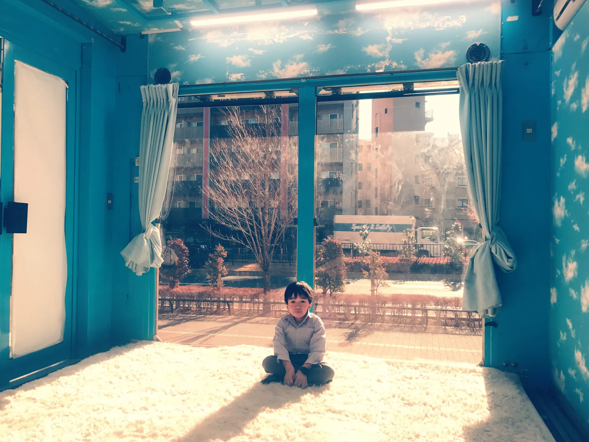 Kohey Nishi, also known as Nishikun, sitting in a sunlit room.